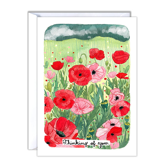 Greeting card with red and pink flowers and 'Thinking of you' text near the bottom of the card