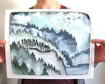 Person holding a watercolor painting of a snowy landscape with trees.