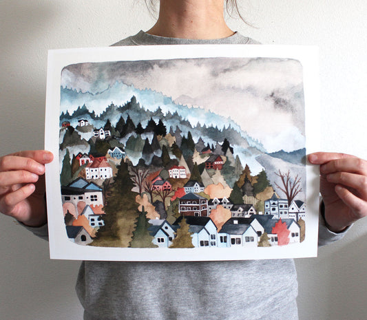 Person holding a watercolor painting of Portland's Northwest Hills.