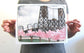 Print of Portland's Steel Bridge with pink Cherry Blossoms blooming along the waterfront. 
