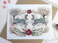 Two Spring Rabbits with Hellebore and Blooming Trees