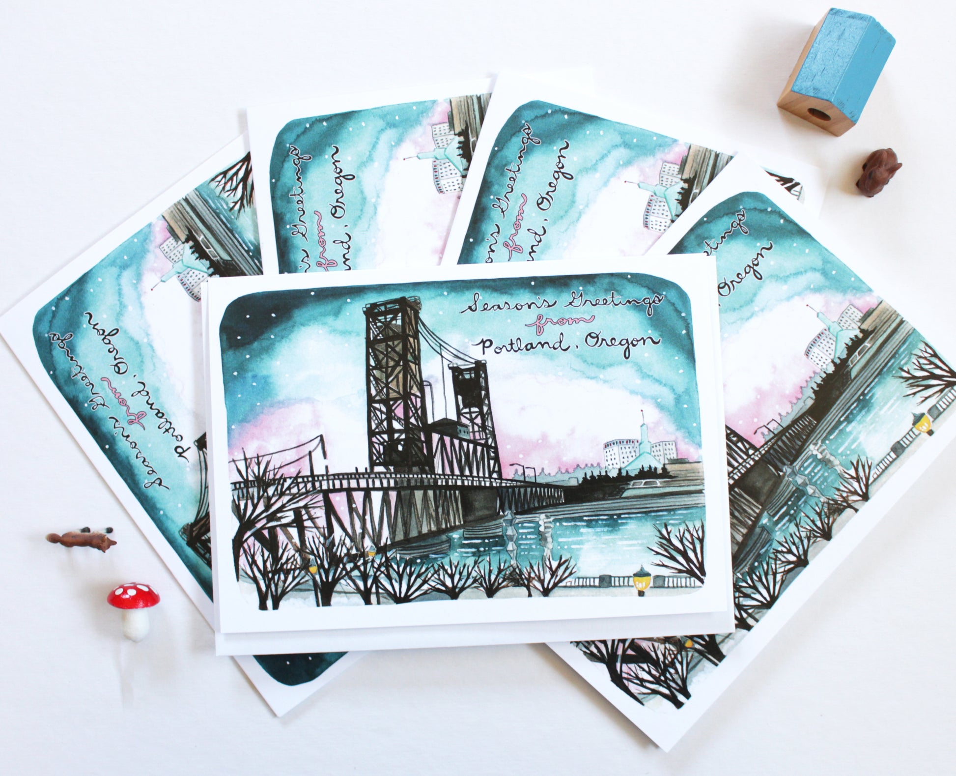 Set of greeting cards with Portland, Oregon's Steel Bridge illustration and text on a white surface